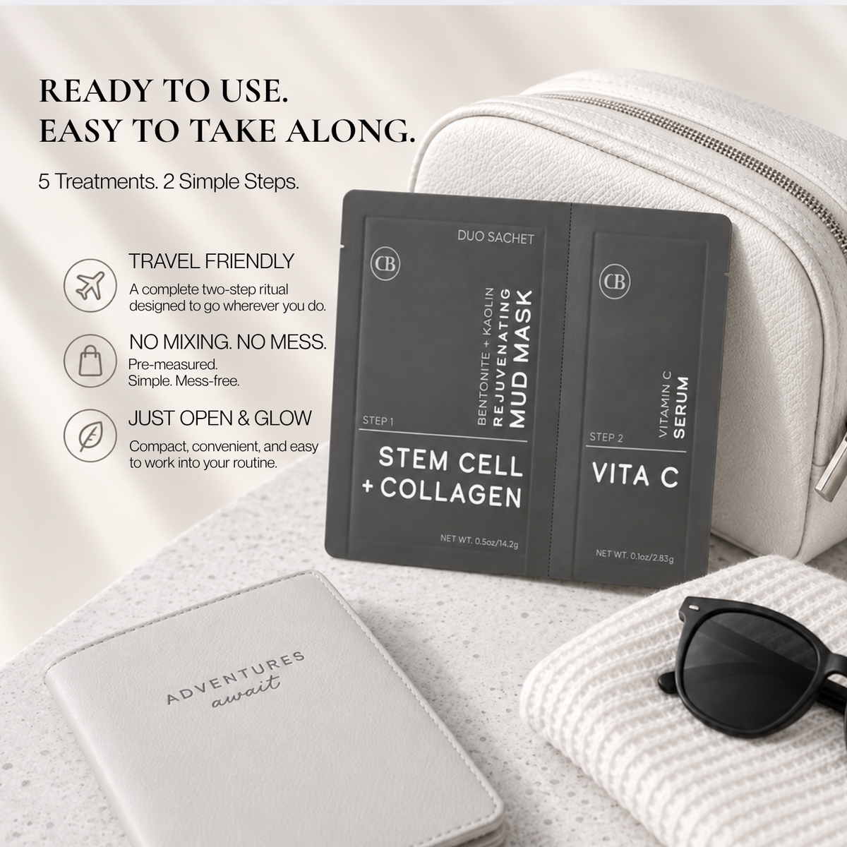 A skincare set displayed on a light stone surface with lifestyle props. The main product is a black two-step mud mask duo sachet labeled &